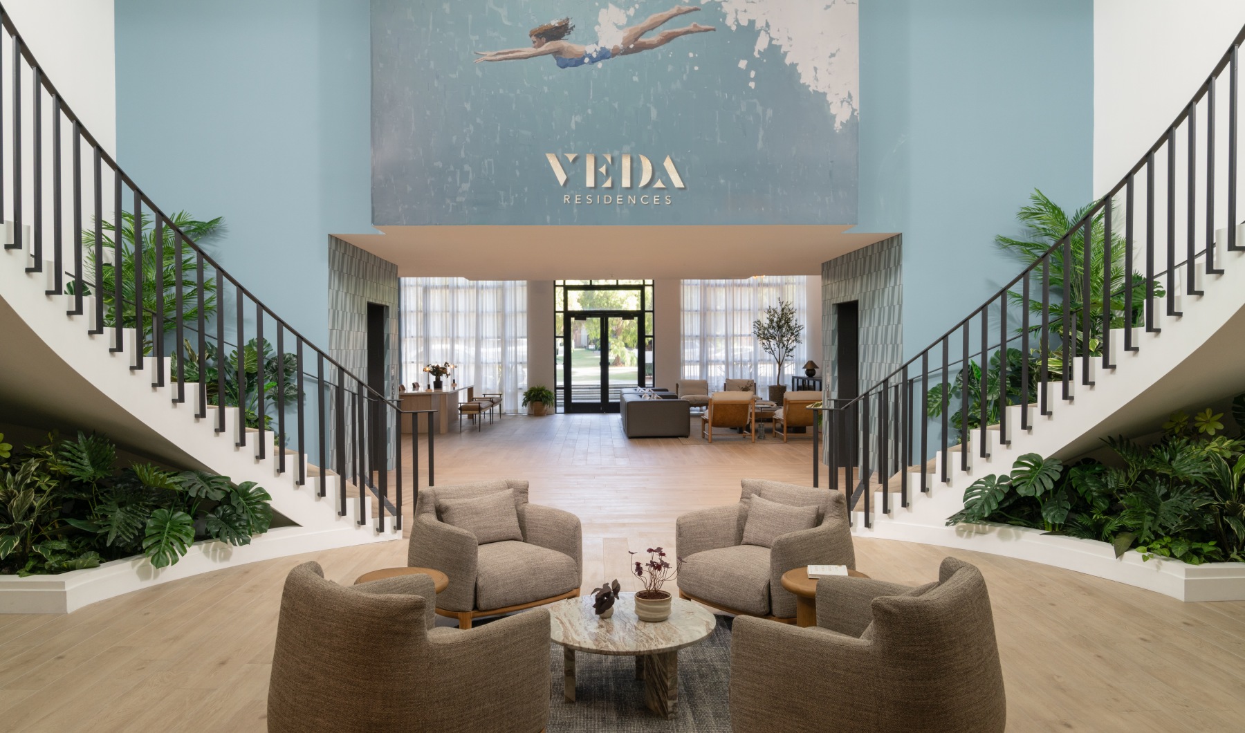veda entrance with two staircases and couches in between