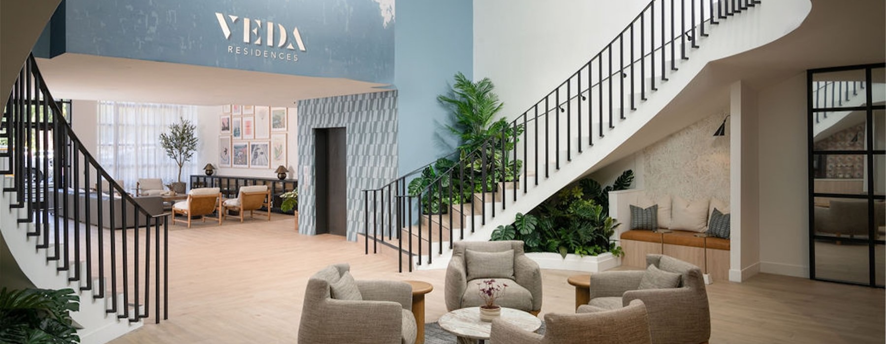 a lobby with stairs and chairs