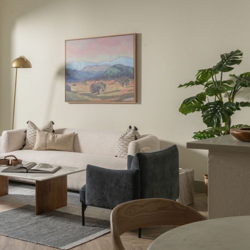 a living room with a couch, a table and chairs