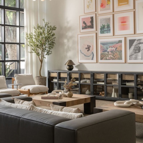 a lounge room with couches, tables and chairs