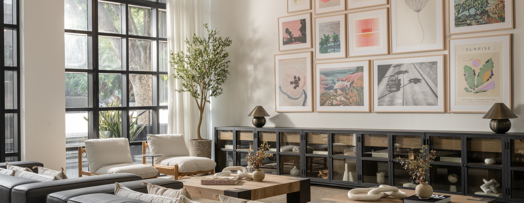 a lounge room with couches, tables and chairs